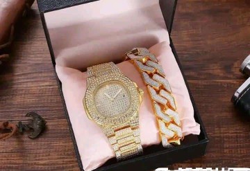 A BLACK BOXED WRIST WATCH AND BANGLES